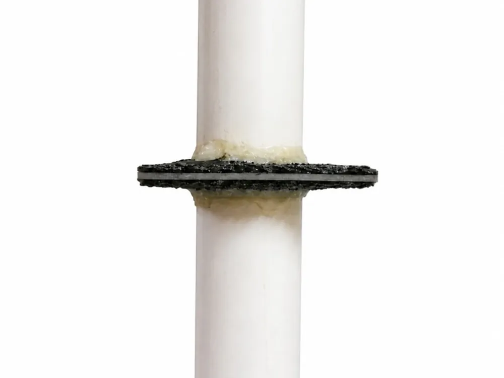 Coarse aggregate moulded PVC puddle flange for concrete bonding
